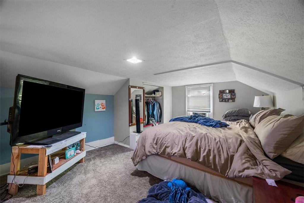 125 Center Avenue Burgettstown, PA 15021 - Photo 25 of 32 a bedroom with a bed and a flat screen tv