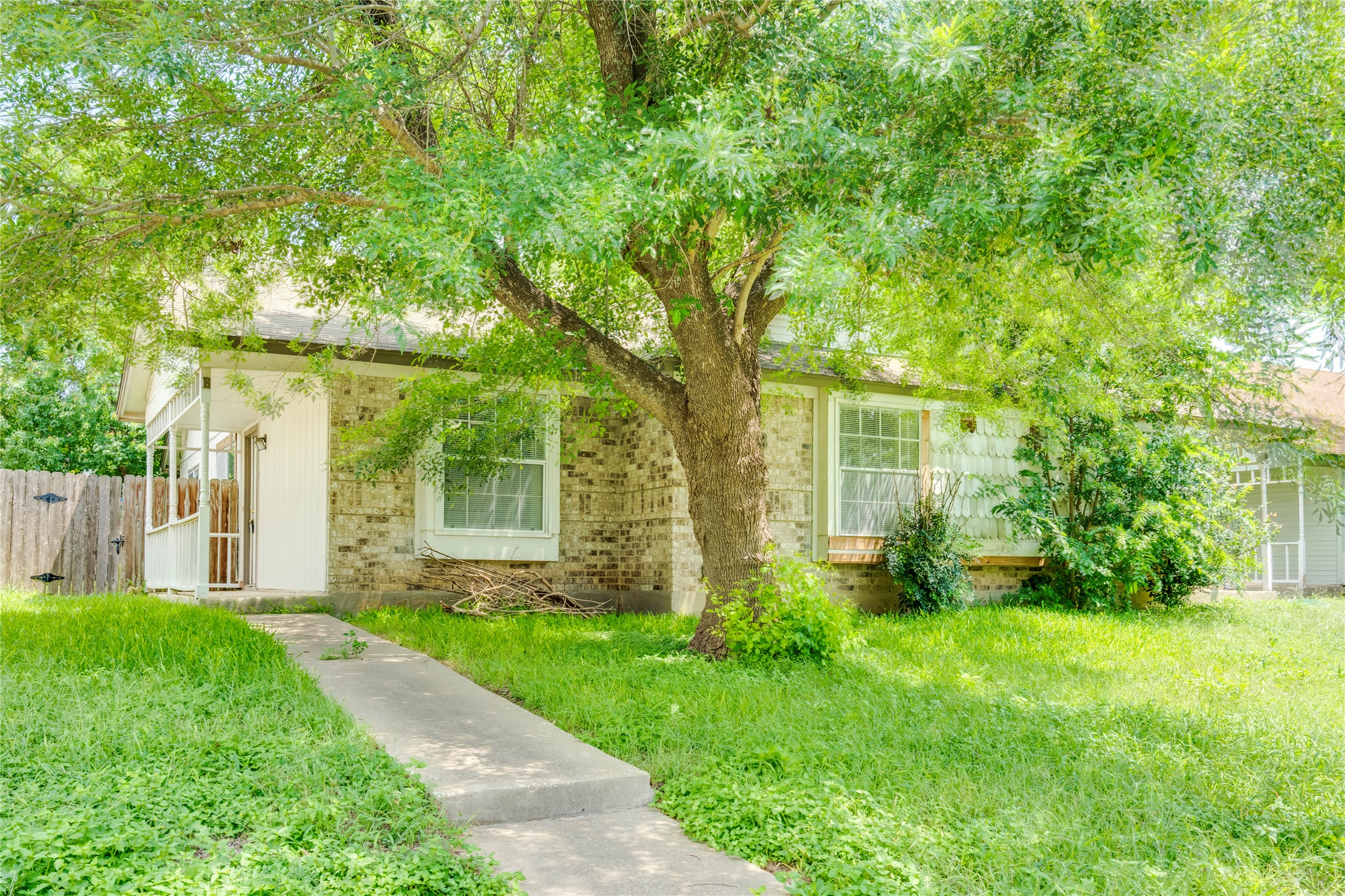 7918 West Gate Boulevard Austin, TX 78745 - Photo 29 of 31 Mature trees canopy the front of this charming brick and siding residence.