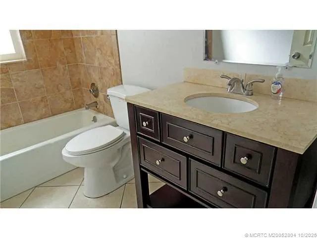 a bathroom with a sink a toilet and bathtub