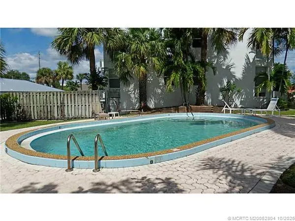 a view of a park with iron fence