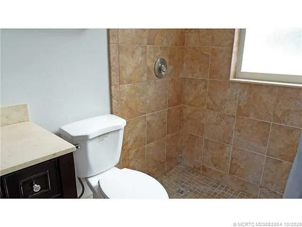 a bathroom with a sink a toilet and a shower