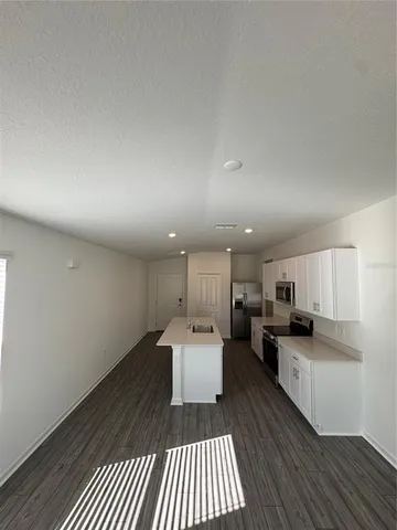 a kitchen with a refrigerator and a sink