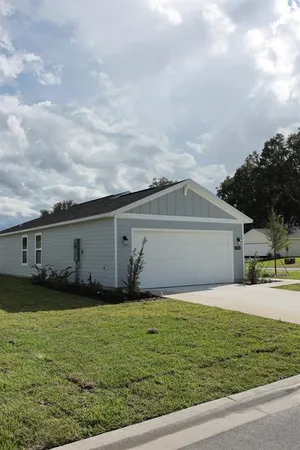 a front view of house with yard and trees