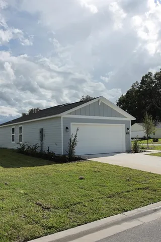 a front view of house with yard and trees