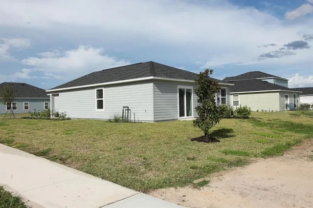 a view of a house with a yard