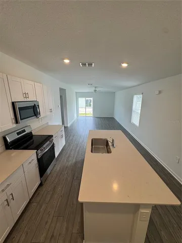 a kitchen with a stove and white cabinets
