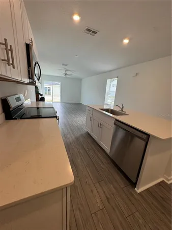 a living room with hard wood floors and a couch