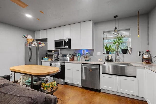 a kitchen with a sink stove and cabinets