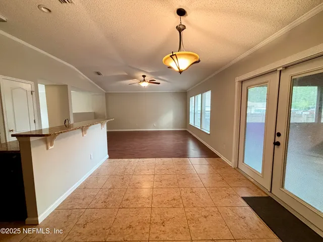 a view of a yard with plants and trees