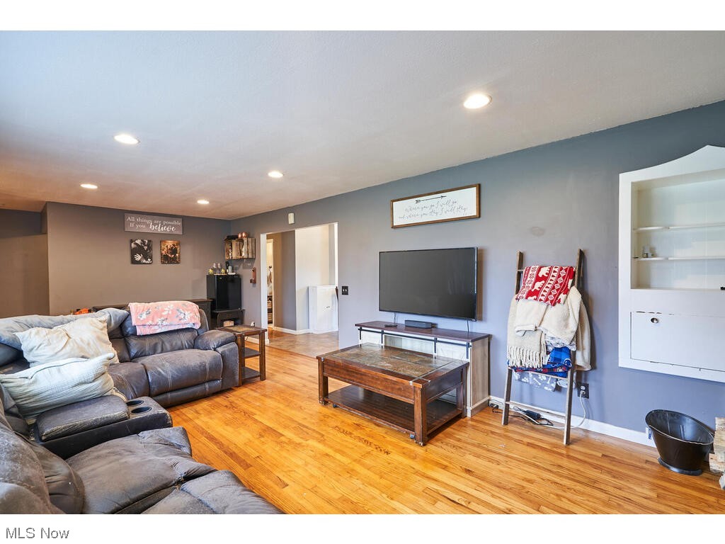 11530 Girdled Road Painesville, OH 44077 - Photo 30 of 32 Living room featuring built in features and light hardwood / wood-style flooring