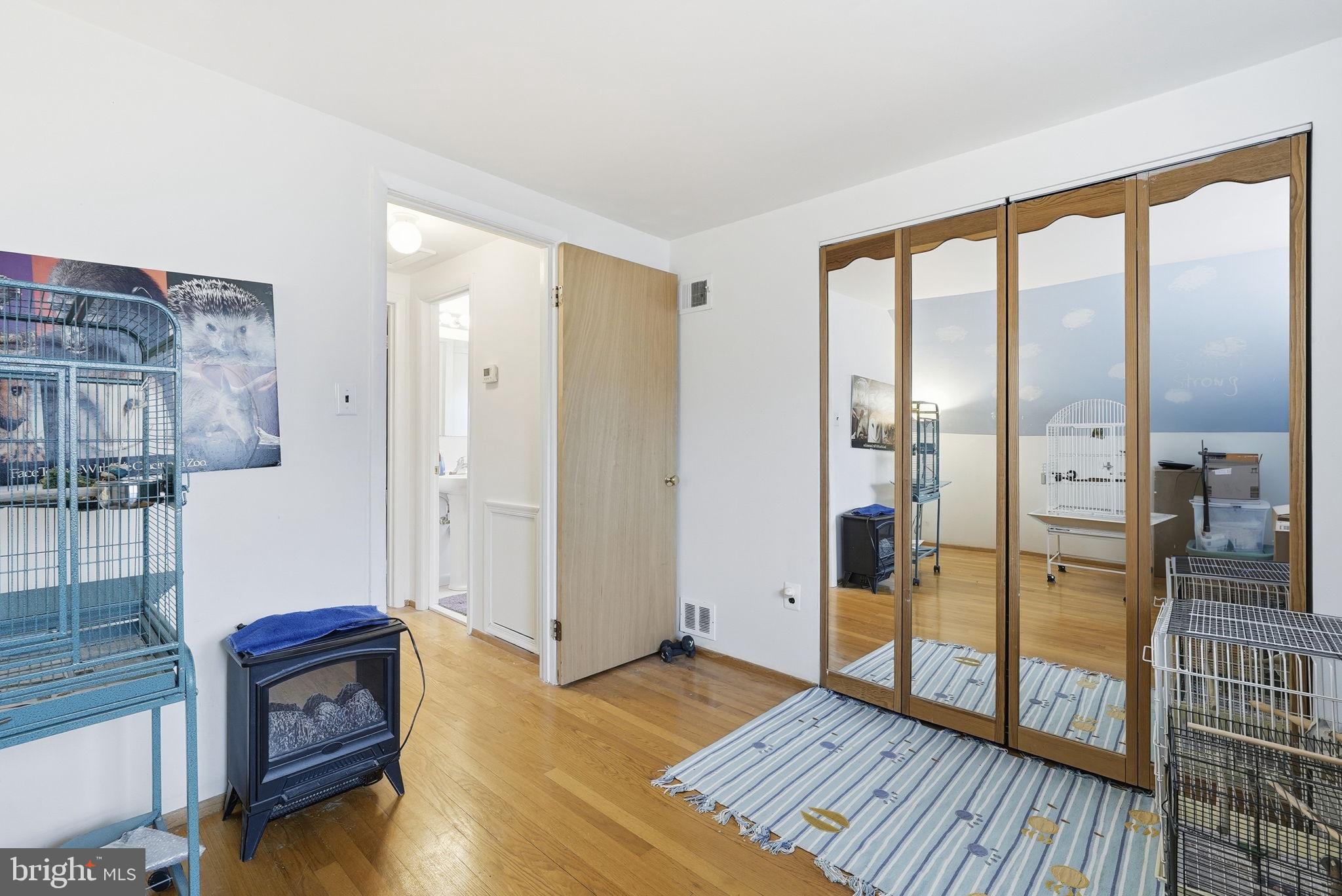 14506 Danville Road Woodbridge, VA 22193 - Photo 16 of 26 a living room with furniture stove and wooden floor