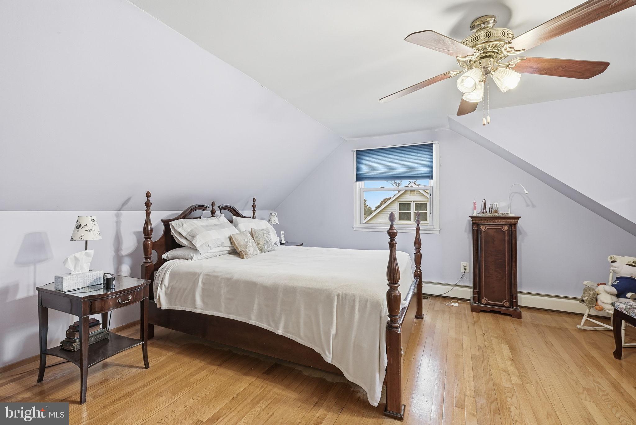14506 Danville Road Woodbridge, VA 22193 - Photo 18 of 26 a bedroom with a bed and a chandelier