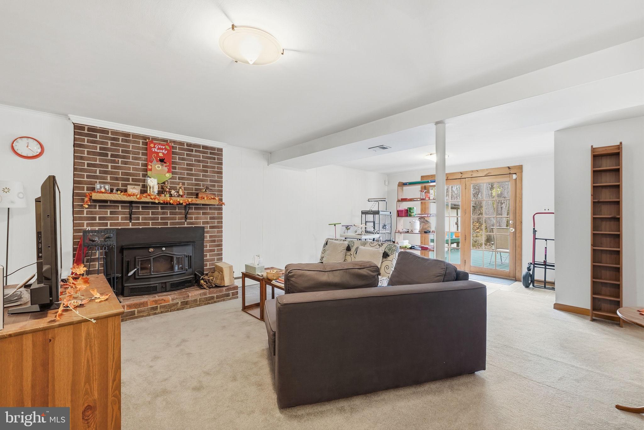 14506 Danville Road Woodbridge, VA 22193 - Photo 21 of 26 a living room with furniture a fireplace and a flat screen tv
