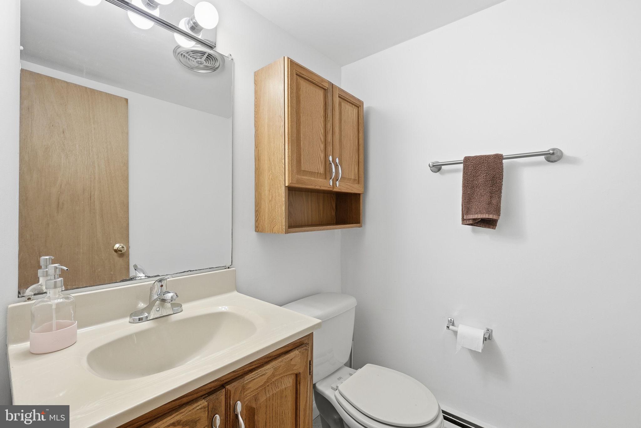 14506 Danville Road Woodbridge, VA 22193 - Photo 22 of 26 a bathroom with a sink vanity mirror and toilet