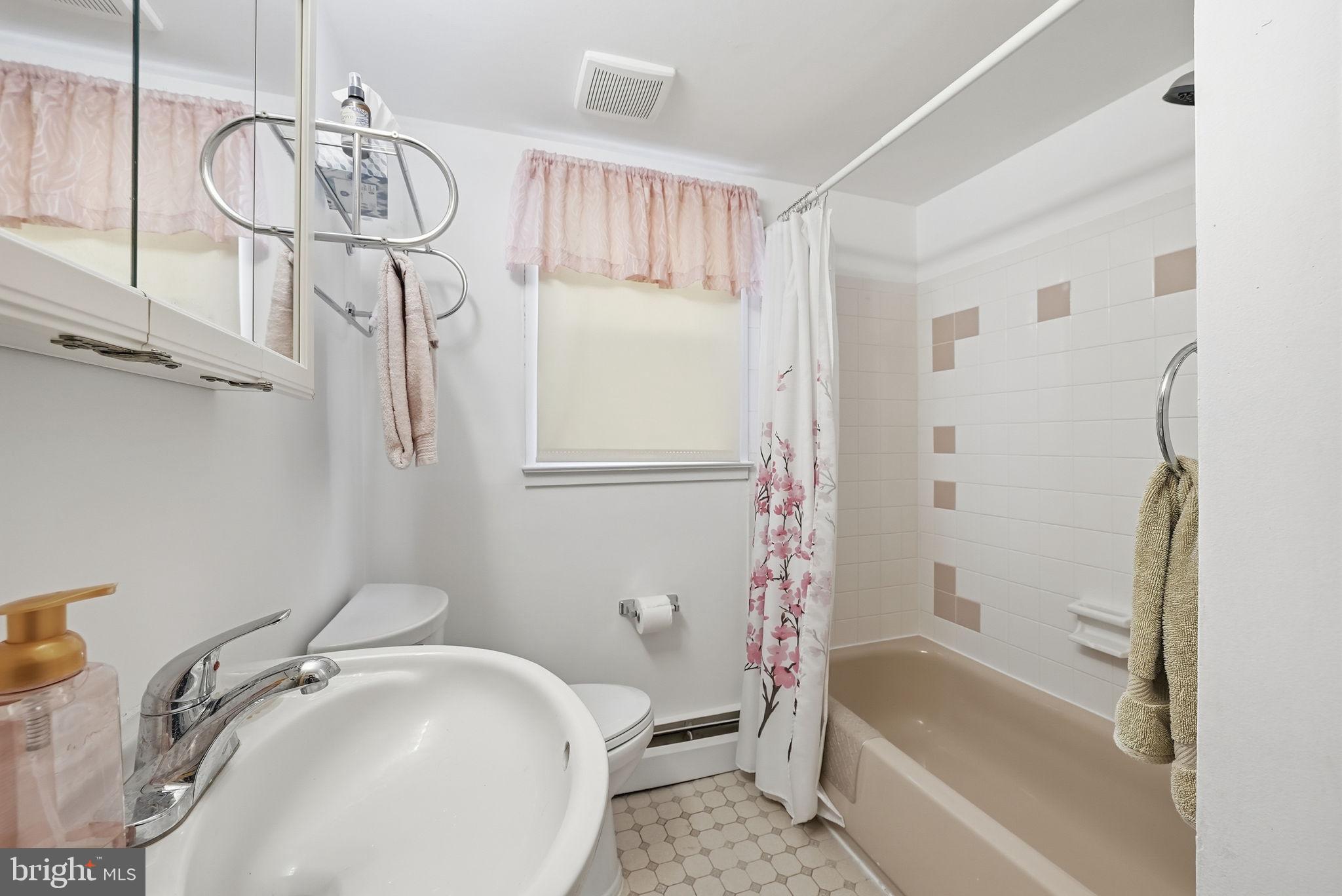 14506 Danville Road Woodbridge, VA 22193 - Photo 7 of 26 a bathroom with a sink a bathtub and a shower