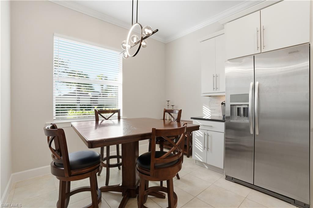 9328 Fieldstone Lane Naples, FL 34120 - Photo 12 of 40 a view of a dining room with furniture window and wooden floor