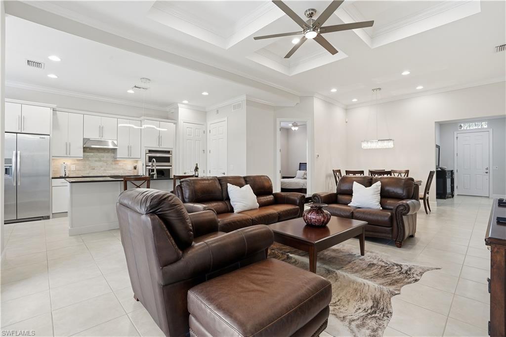 9328 Fieldstone Lane Naples, FL 34120 - Photo 5 of 40 a living room with furniture kitchen view and a refrigerator