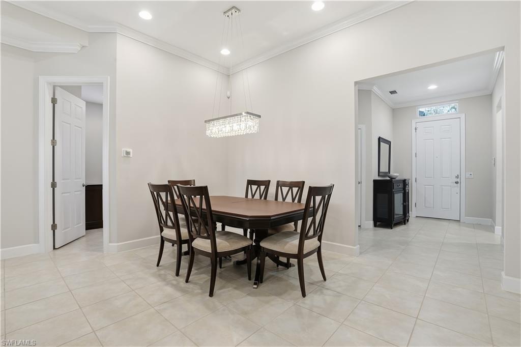 9328 Fieldstone Lane Naples, FL 34120 - Photo 7 of 40 a dining room with furniture and wooden floor