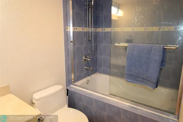 a bathroom with a bathtub and a toilet