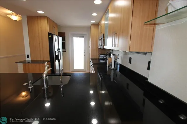 a very nice looking dining room with furniture and chandelier