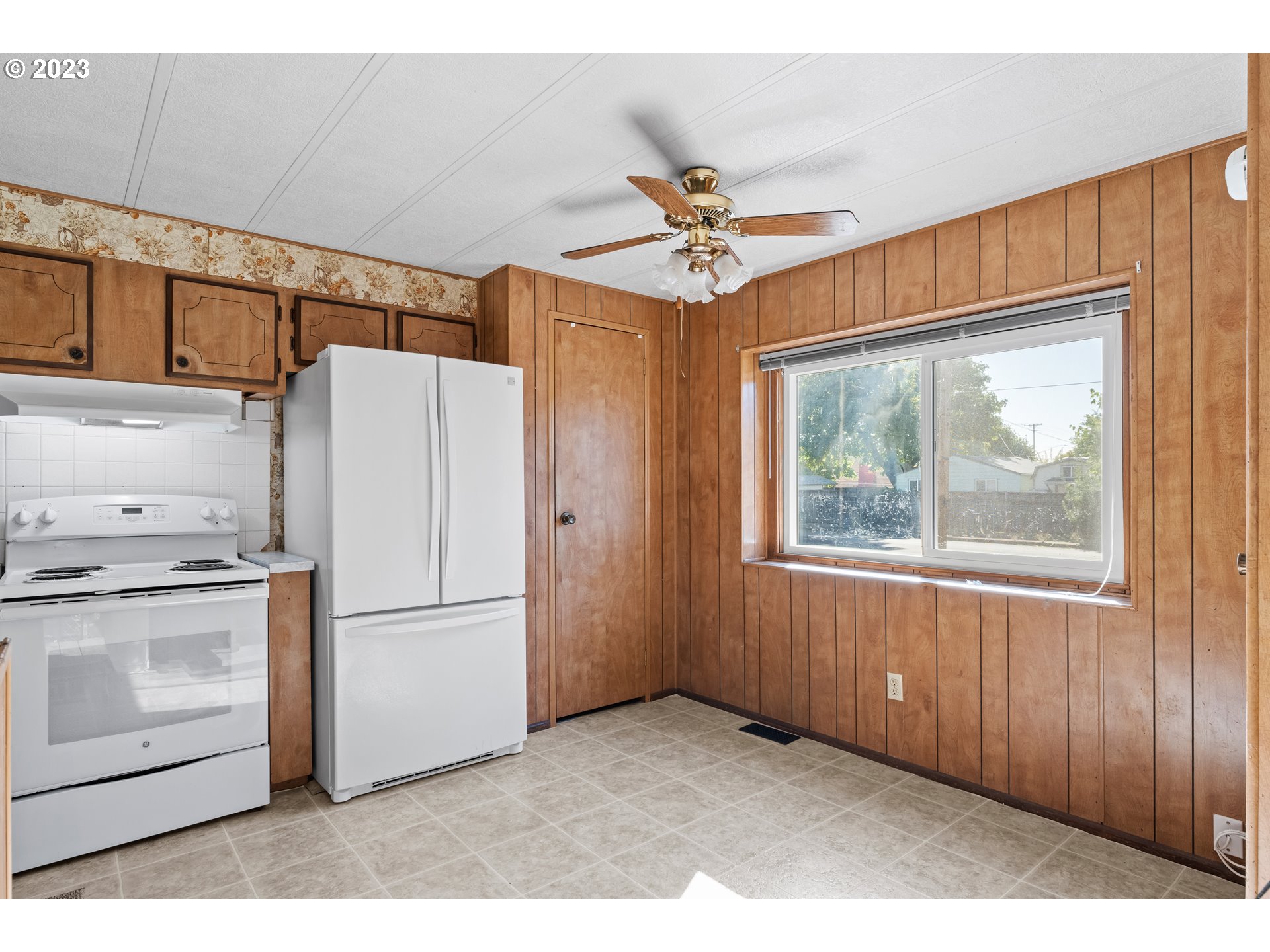 1117 34th Street Springfield, OR 97478 - Photo 13 of 39 a kitchen with stainless steel appliances a refrigerator and a stove top oven