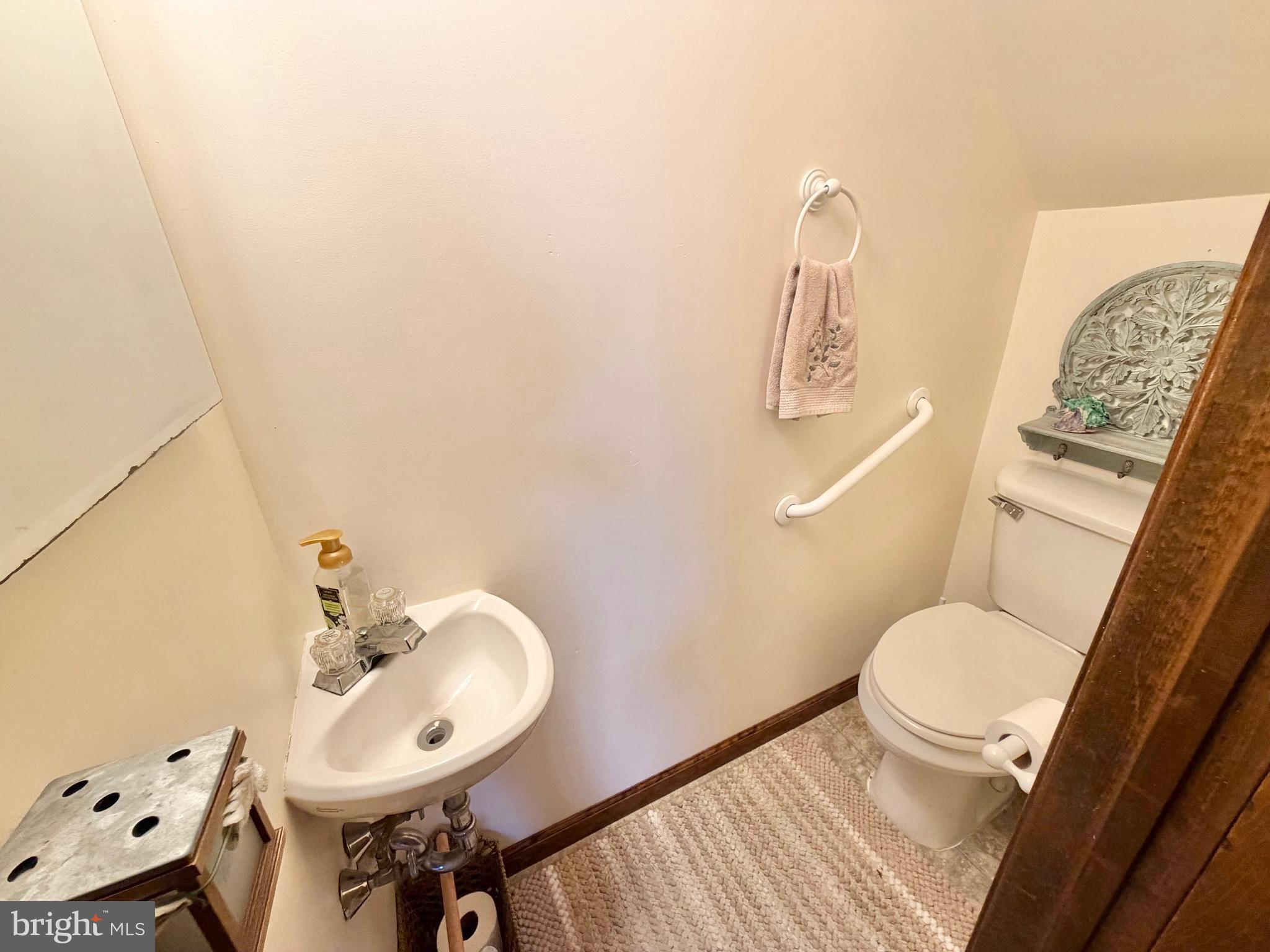 126 4th Avenue Roebling, NJ 08554 - Photo 21 of 43 a bathroom with a toilet a sink and mirror