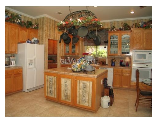 2486 Rye Beach Lane Henderson, NV 89052 - Photo 5 of 18 Kitchen. Ralph Lauren paint design in the kitchen with glass front cabinets and neutral tile counters!