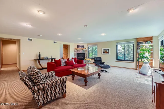 a living room with furniture and large window