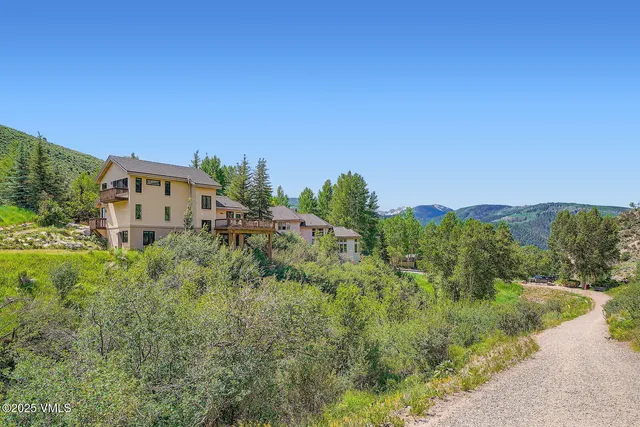 a view of a house with a yard and mountain