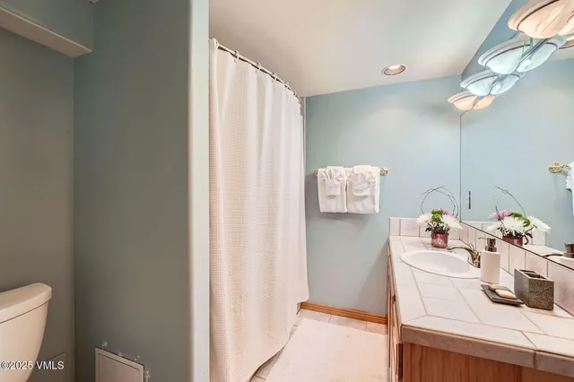 a bathroom with a sink toilet and vanity