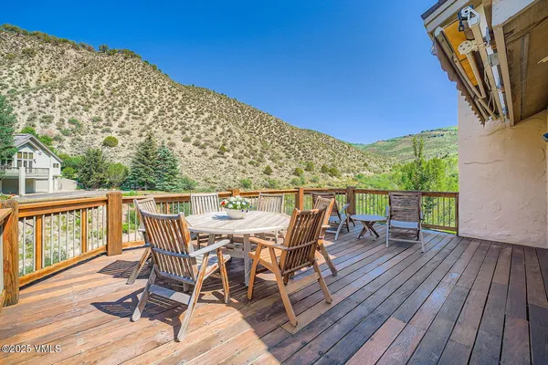 a view of a balcony with furniture and wooden floor