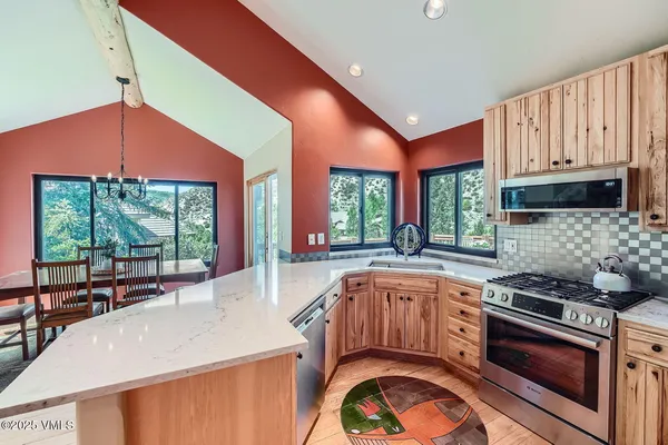 a kitchen with stainless steel appliances a stove a sink and a refrigerator