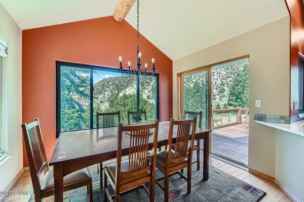 a view of a dining room with furniture large windows and wooden floor