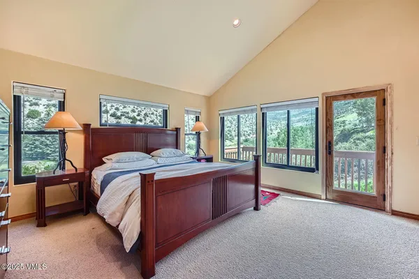 a bed sitting in a room next to a balcony