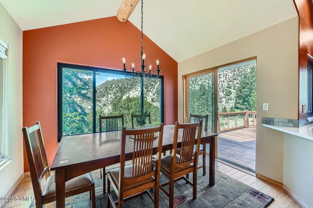 a view of a dining room with furniture large windows and wooden floor