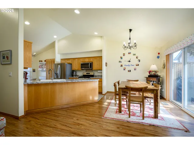 a living room with kitchen view and wooden floor