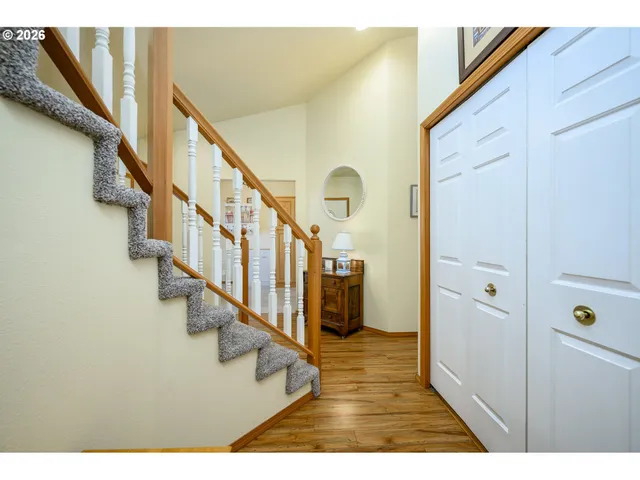 a view of entryway and hall with wooden floor