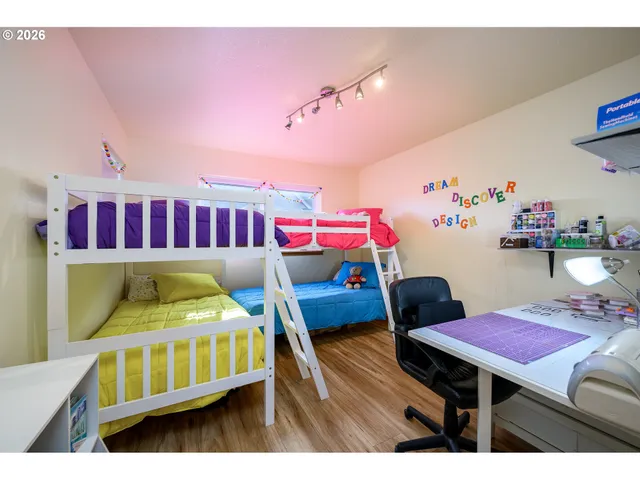 a bedroom with furniture and a wooden floor
