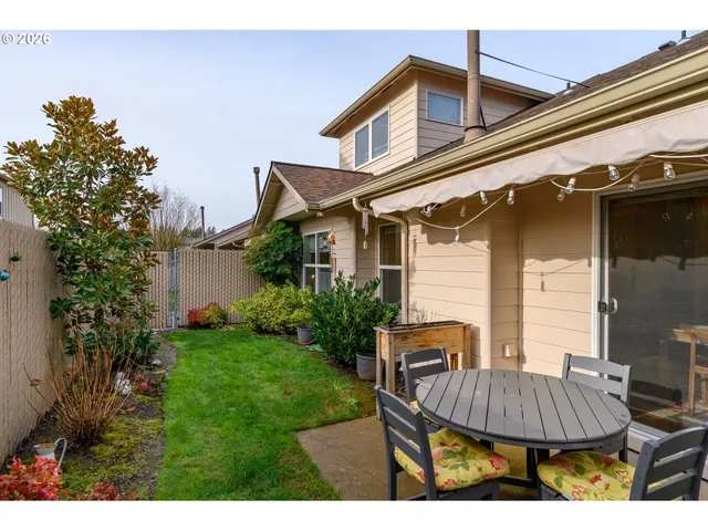 a view of a house with backyard and sitting area