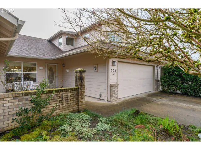 front view of a house with a tree
