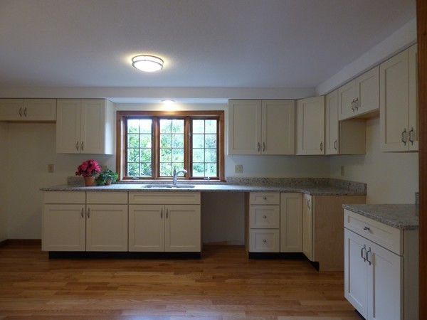 560 Station Road Amherst, MA 01002 - Photo 3 of 30 a kitchen with granite countertop white cabinets stainless steel appliances a sink and a window