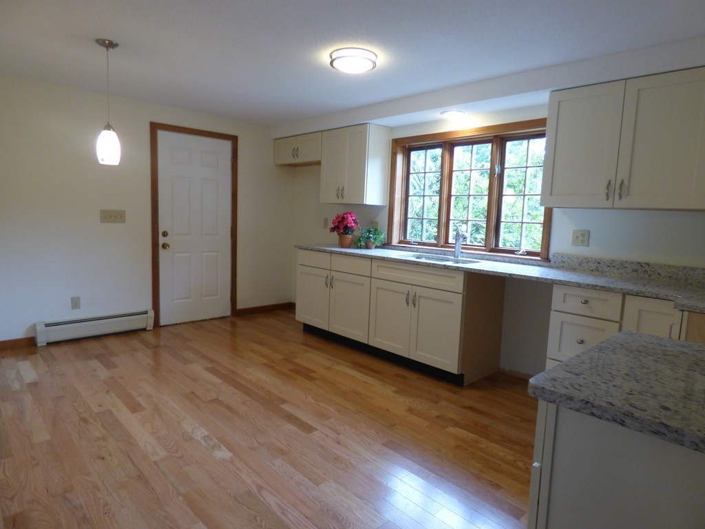 560 Station Road Amherst, MA 01002 - Photo 6 of 30 a kitchen with granite countertop a stove and a sink