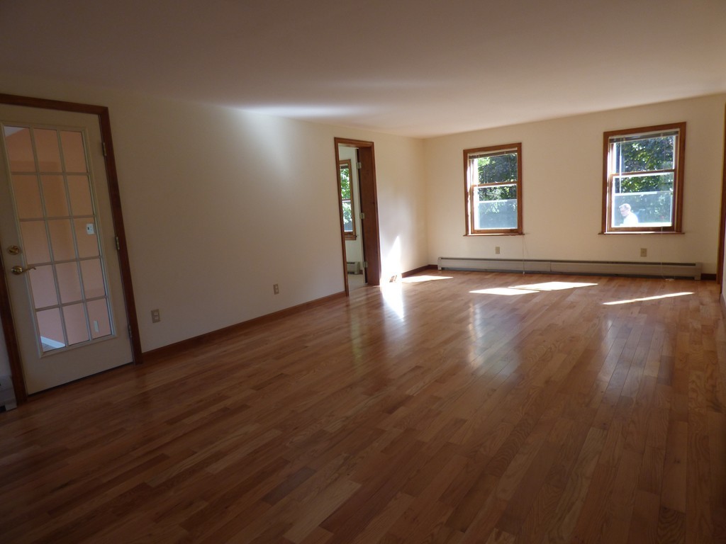560 Station Road Amherst, MA 01002 - Photo 8 of 30 an empty room with wooden floor and windows