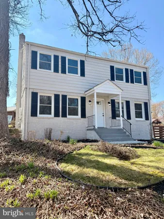 a house with swimming pool in front of it