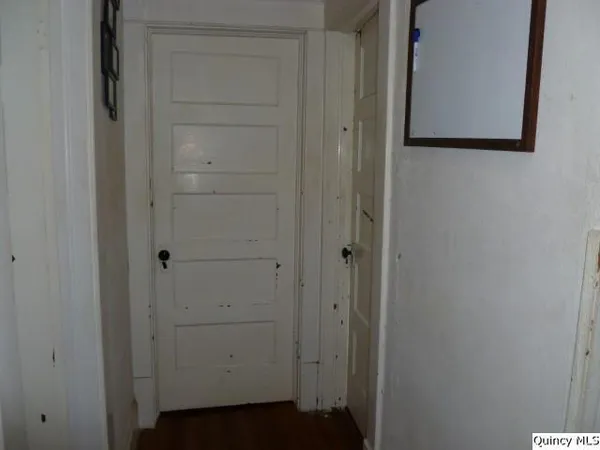 a view of wooden floor and window in a room