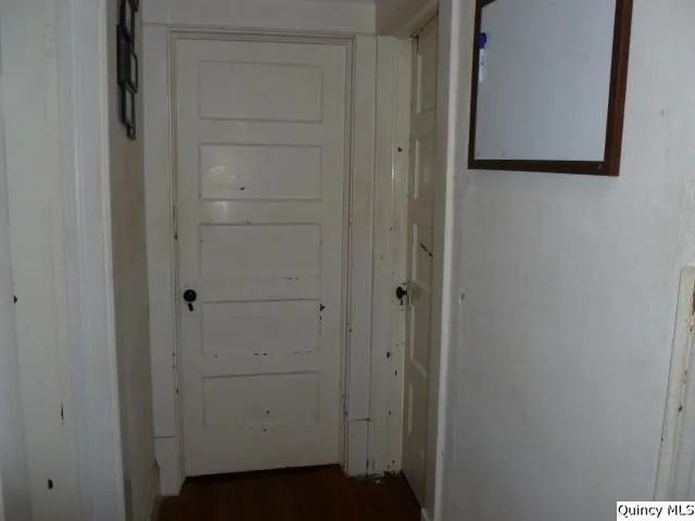 a view of wooden floor and window in a room