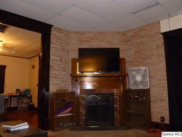 a living room with fireplace and a flat screen tv