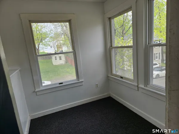 a view of an empty room with a window