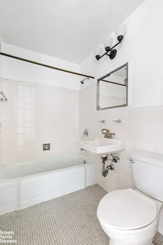 a bathroom with a sink toilet a mirror and shower