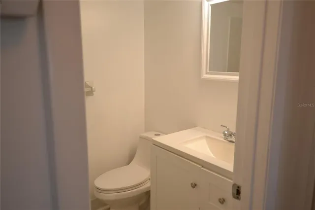 a white toilet sitting next to a bathroom sink